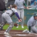 KEITH THORPE/PENINSULA DAILY NEWS
Port Angeles' Kaleb Mullen, right, looks back at North Kitsap catcher Greyson Prichard after making it home in the second inning as Mullen's teammate, Rylan Politia waits to bat on Tuesday at Volunteer Field.