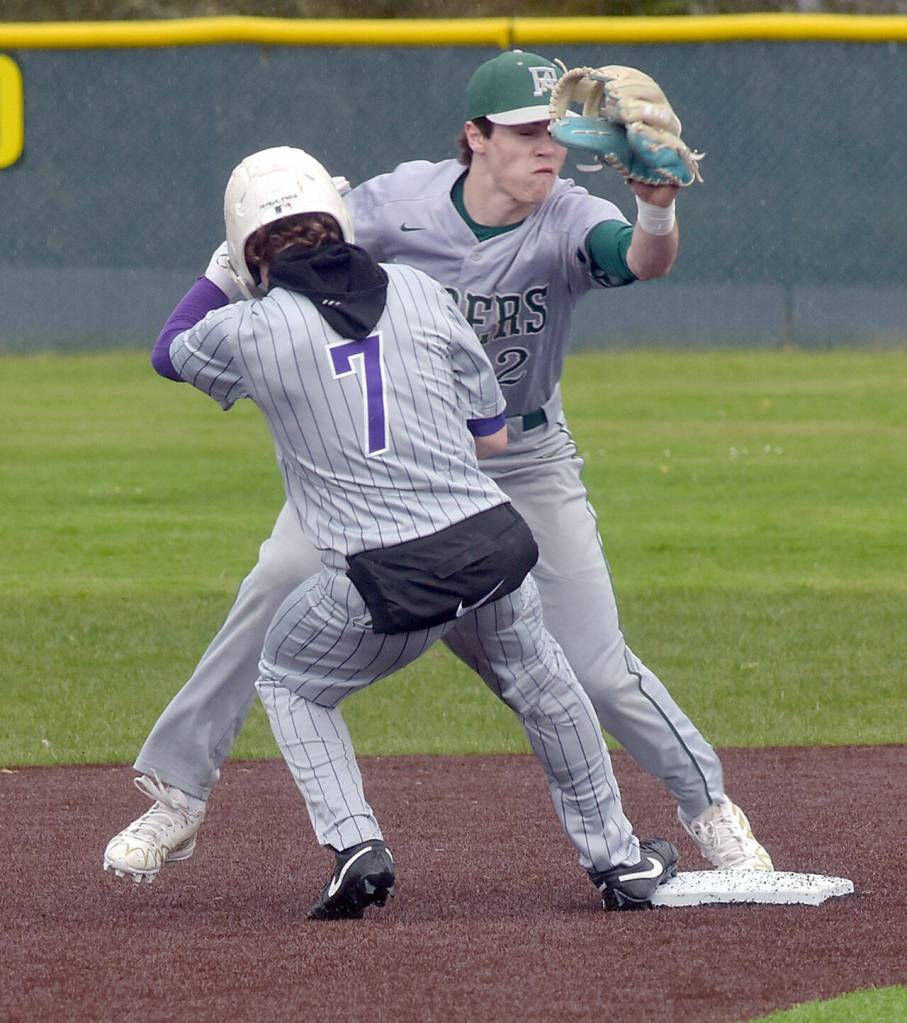 KEITH THORPE/PENINSULA DAILY NEWS Port Angeles shortstop Alex Angevine, right, tries to catch North Kitsap baserunner Alex Elton off the bag at second on Tuesday at Volunteer Field.
