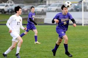 Sequim's Simon Hare (15) heads the ball against Bainbridge in Sequim on Tuesday. (Michael Dashiell/Olympic Peninsula News Group)