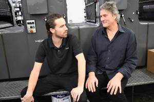 Mike Kenna, right, owner of Printery Communications,has purchased SOS Printing to keep the business running after owner Dan Huntingford’s sudden illness. Son Rory Kenna is at left. (Jeannie McMacken/Peninsula Daily News)