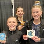 Klahhane Xcel gymnasts, from left, Elyse Brown, Mariah Traband and Scarlett Sullivan all qualified for regionals at the Washington State Xcel Championship held in Pasco this weekend. Brown won a first-place medal for the floor exercise. (Klahhane Gymnastics)