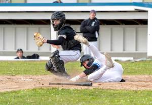 Steve Mullensky/for Peninsula Daily News
East Jefferson's Cash Holmes tumbles into home for a run during a game against Klahowya on Monday in Chimacum. Despite the Eagles coming in to Monday's game as the defending 1A state champion, East Jefferson gave Klahowya a tough game, but fell in the end 5-4.