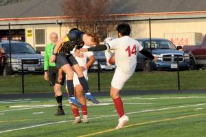 Forks Brody Owen, left, goes head-to-toe with Hoquiams Daniel Rosales on Wednesday evening at Spartan Stadium. (Lonnie Archibald/for Peninsula Daily News)