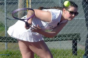 Port Angeles Waverly Mead leans low for the return during her singles match against Bainbridges Izzy Wallin on Wednesday afternoon in Port Angeles. (Keith Thorpe/Peninsula Daily News)