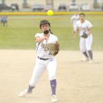 With teammate Taylee Rome looking on, Sequim second baseman Mia Kirner throws out a Klahowya runner in a non-league match-up Saturday. Kirner had a home run in the windy game. (Michael Dashiell/Olympic Peninsula News Group)