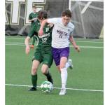 Port Angeles soccer player Cannon Wood (12) is elbowed out of the way by North Kitsap’s Ethan Peck (11) Friday night at Wally Sigmar Field at Peninsula College. (Dave Logan/for Peninsula Daily News).