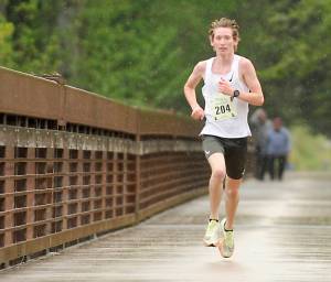 Men's 5K winner Langdon Larson of Port Angeles reaches the finish line at the Sequim Railroad Bridge Run. Larson won the 5K by nearly two minutes. (Michael Dashiell/Olympic Peninsula News Group)