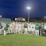 Port Angeles baseball players and coaches celebrate with a team photo on the field at Cheney Stadium after beating King's 6-5 Wednesday night in the Roughriders' regular season finale.
