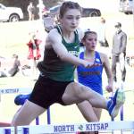 Nicholas Zellar-Singh/Kitsap News Group Port Angeles Faerin Tait leaps during the 100-meter hurdles Thursday at the Olympic League Track and Field Championship at North Kitsap High School.