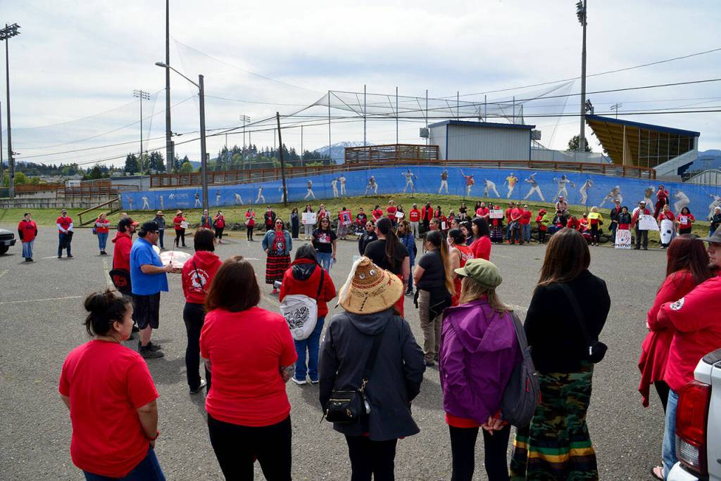 Nearly 200 people marched from the Lower Elwha Klallam Hertiage Center on First Street to Civic Field in Port Angeles on Friday, wearing red in honor of Missing and Murdered Indigenous Peoples Day. The march had planned to walk to the Gateway Transit Center in downtown Port Angeles, but it had to reroute due to law enforcement activity. (Peter Segall/Peninsula Daily News)