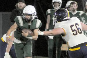 KEITH THORPE/PENINSULA DAILY NEWS
Port Angeles' Kason Albaugh tries to evade the defense of Bainbridge's Emmett Taylor on Friday night at Port Angeles Civic Field.