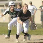 Port Angeles Ava-Anne Sheahan takes a lead off first base behind Sequim first baseman Ava Ritter on Friday in Sequim. (Michael Dashiell/Olympic Peninsula News Group)