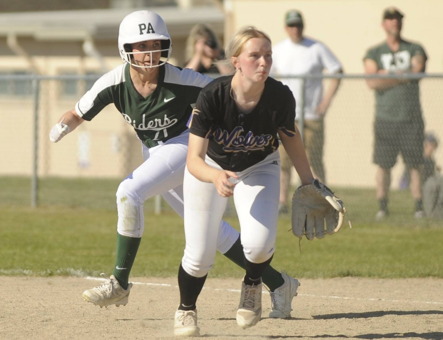 Port Angeles Ava-Anne Sheahan takes a lead off first base behind Sequim first baseman Ava Ritter on Friday in Sequim. (Michael Dashiell/Olympic Peninsula News Group)