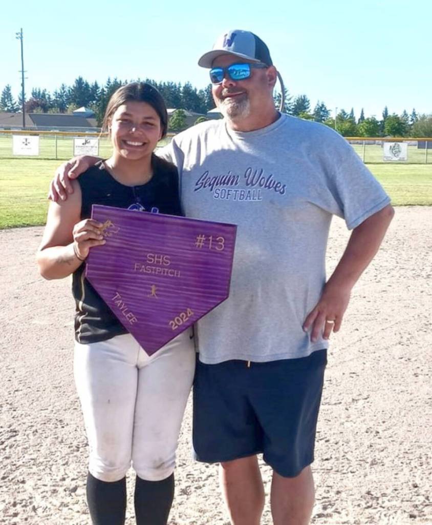 Sequim senior Taylee Rome is honored after Fridays game against Port Angeles, along with her coach Mike McFarlen. Rome finished the season with a .644 batting average. (Pierre LaBossiere/Peninsula Daily News)