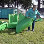 Roxanne Pfiefer-Fisher, a volunteer with a team from Walmart, sorts through sections of what will become a slide during Wednesdays opening day of a community rebuild of the Dream Playground at Erickson Playfield in Port Angeles. (Keith Thorpe/Peninsula Daily News)