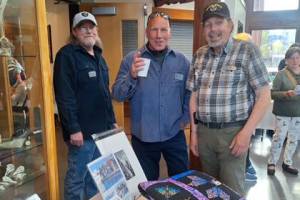 Sarges Veteran Support house managers, from left, Danny Deckert, David Durnford and Steve Elmelund welcome attendees to the organizations first fundraiser at the Dungeness River Nature Center on April 27. The event raised nearly $50,000. (Sarges Veteran Support)