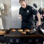 Port Angeles Fire Department community paramedic Brian Gerdes flips pancakes during Saturdays annual breakfast on Saturday at the fire hall. The event, hosted by the fire department and auxiliary, was a fundraiser for department scholarships and relief baskets. (Keith Thorpe/Peninsula Daily News)