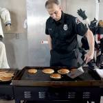 Port Angeles Fire Department community paramedic Brian Gerdes flips pancakes during Saturdays annual breakfast on Saturday at the fire hall. The event, hosted by the fire department and auxiliary, was a fundraiser for department scholarships and relief baskets. (Keith Thorpe/Peninsula Daily News)