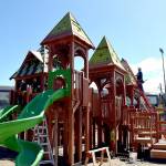 Volunteers work to construct the main play structure of the Dream Playground at Erickson Playfield in Port Angeles on Sunday, the last day of a five-day community build to replace play equipment destroyed by arson in December. The playground, built entirely with donated labor, will be substantially complete with primarily detail work and play surface installation still to come. (Keith Thorpe/Peninsula Daily News)