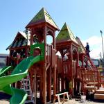 Volunteers work to construct the main play structure of the Dream Playground at Erickson Playfield in Port Angeles on Sunday, the last day of a five-day community build to replace play equipment destroyed by arson in December. The playground, built entirely with donated labor, will be substantially complete with primarily detail work and play surface installation still to come. (Keith Thorpe/Peninsula Daily News)