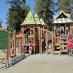 Volunteers work to construct the main play structure of the Dream Playground at Erickson Playfield in Port Angeles on Sunday, the last day of a five-day community build to replace play equipment destroyed by arson in December. The playground, built entirely with donated labor, will be substantially complete with primarily detail work and play surface installation still to come. (Keith Thorpe/Peninsula Daily News)