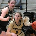 Keith Thorpe/Peninsula Daily News
Peninsula's Millie Long, right, drives past the defense of Shoreline's Symone Pease during Wednesday's season finale in Port Angeles.