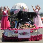 This years Rhododendron Festival queen Paige Govia and princess Rosie Schmucker wave to the Sequim Irrigation Festival Grand Parade crowd on May 11. (Michael Dashiell/Olympic Peninsula News Group)