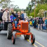 Tom Rose, owner of the building housing the Nordland General Store, leads a parade with his vintage 1940 Allis-Chalmers tractor on Sunday on Marrowstone Island. The general store, which has been a mainstay on the island since 1922, was closed for six years due to a fire that destroyed the inside of the building. A grand re-opening and ribbon cutting was held Saturday to celebrate the opening as a co-op. (Steve Mullensky/for Peninsula Daily News)