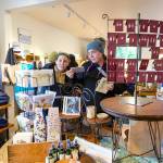 Customers at the Nordland General Store on Marrowstone Island look over cards and other items during a weekend of activities to celebrate the re-opening of the store after it had been closed for six years due to a fire. (Steve Mullensky/for Peninsula Daily News)