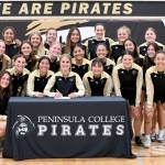 Peninsula Colleges Hannah Wagner of Sequim signs to play soccer for Vancouver Island University surrounded by her teammates and assistant coach Andrew Cooper and head coach Kanyon Anderson. Wagner was also the womens soccer team recipient of the Wally Sigmar and Art Feiro awards for leadership, academics and citizenship. (Peninsula College)