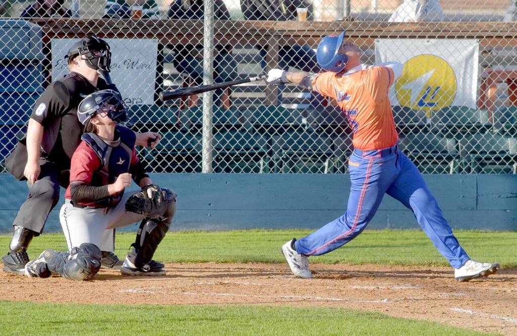 KEITH THORPE/PENINSULA DAILY NEWS Lefties designated hitter Colin Spear hits a popup in the fourth inning as Redmond catcher Halen Otte keeps watch on Wednesday at Port Angeles Civic Field.