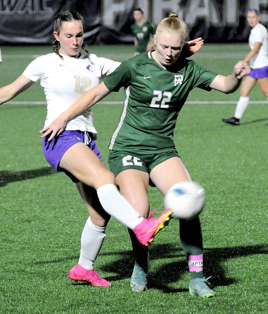 KEITH THORPE/PENINSULA DAILY NEWS Sequims Olive Bridge, left, gets the ball away from Port Angele Paige Mason during Tuesday nights match at Peninsula College in Port Angeles.