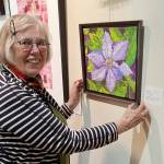 Liisa Fagerlund with a bead-embellished floral image on display at the A. Milligan Gallery on North Sequim Avenue.