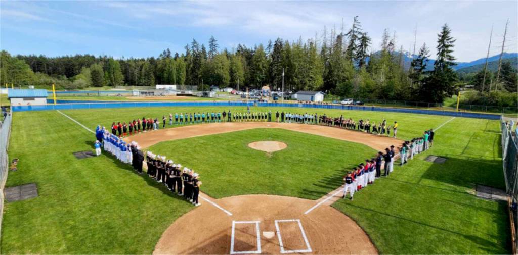 The various teams participating in the North Olympic Baseball and Softball Port Angeles city championship take part in pre-game ceremonies this weekend at Volunteer Field. (Courtesy of NOBAS)