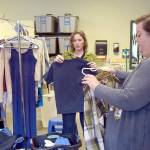 Alicia Scofield, left, and Summer Cooper, family navigators for the Port Angeles School District, sort over donated clothing available to students and their families at the Caring for Kids Clothing Closet located at Lincoln Center. (Keith Thorpe/Peninsula Daily News)