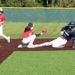 Garret Buerer of the Westport team tries to steal second base on Tuesday night in the Olympic Junior Babe Ruth semifinal, but is put out by Local 155s Ethan Barbree as he slides. Local 155 second baseman Brayden Scott backs up the play. Westport won 4-0 to qualify for the championship game at 5:30 p.m. Tuesday at Volunteer Park, against the winner of Athletes Choice and First Federal. (Dave Logan/for Peninsula Daily News)