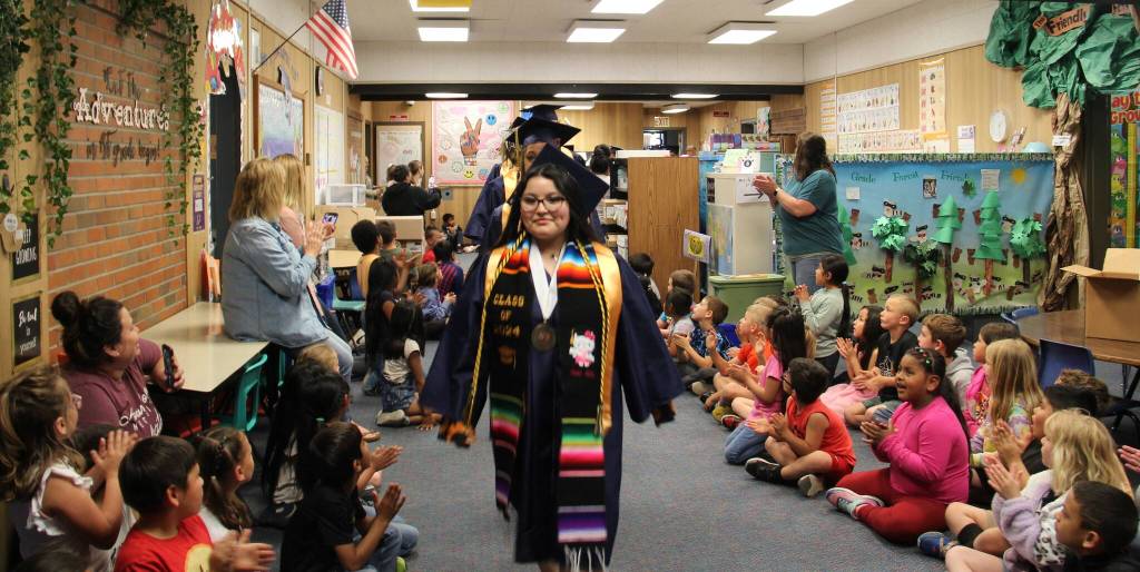 Forks High School graduates walk the halls of Quillayute Valley School District schools June 7 before graduation the following day. They started at Forks Elementary and continued on to the other buildings, then boarded a school bus and rode through town, culminating in a walk through Forks Outfitters. (Christi Baron/Olympic Peninsula News Group)