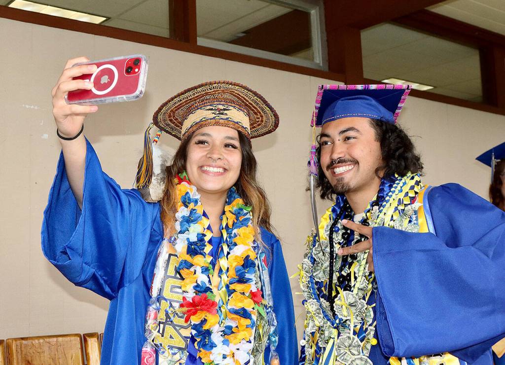 Ciara Cargo-Acosta takes a selfie along with fellow graduate Peyton Watson before Crescent High Schools graduation ceremony on Friday. There were 17 graduates in this years class. This years class flew to San Diego to see the zoo, Balboa Park and Sea World. (Dave Logan/for Peninsula Daily News)