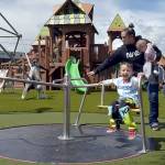 KEITH THORPE/PENINSULA DAILY NEWS
Three-year-old Archie Hanson takes a spin on a merry-go-round pushed by his mother, Justine Hanson of Port Angeles, with sister Arlene Hanson 7 months, during Sunday's grand reopening of the Dream Playground at Erickson Playfield in Port Angeles. The playground was rebuilt earlier this month by volunteers after an arson fire destroyed much of the playground equipment in December. Although there are still details to attend to and minor adjustments to be made, the facility will be open daily from dawn until dusk.
