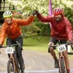 Erin Uloth, left, and Reid Parker, both of Bellingham, celebrate at Worthington Park in Quilcene finishing the Gran Fondo division during the Gravel Unravel. (David Goetze)
