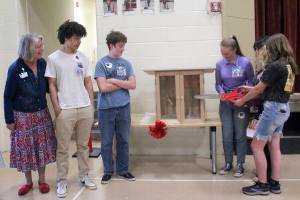 Pictured left to right, Ginny Wagner, Xxzavyon (XJ) Square, Ewan Mordecai-Smith, Elise Sirguy, Mahayla Amendolare and Mallory Hartman cut the ribbon of the little free library at Jefferson Elementary School on Friday. (Darlene Cook)
