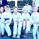 A group of White Crane Martial Arts students rest between performances at a Port Angeles Lefties game at Civic Field. From left, are Sophia Gallon, August Gallon, Noah Larson, Skye Larson and Alexandra Gmazel. (White Crane Martial Arts)