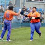 Spencer Dickinson of Saipan is greeted at home plate at Civic Field on Sunday by teammate Zach Blair after hitting a home run for the Port Angeles Lefties. (Dave Logan/for Peninsula Daily News)