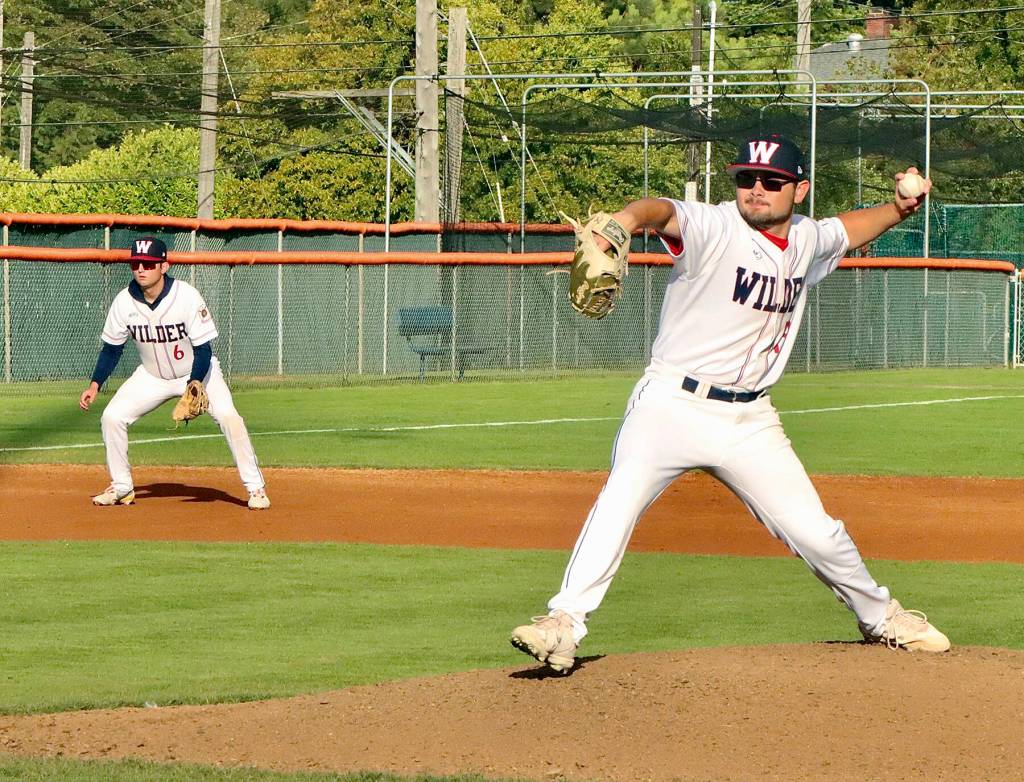 Dave Logan/for Peninsula Daily News
Wilder pitcher Kody Williams winds up to throw in the first inning of Wilder Seniors 10-0 win over Cascade Baseball Club Crush at Civic Field on Thursday. Wilders Cody Romero backs up the play at third base.