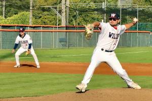 Dave Logan/for Peninsula Daily News
Wilder pitcher Kody Williams winds up to throw in the first inning of Wilder Senior's 10-0 win over Cascade Baseball Club Crush at Civic Field on Thursday. Wilder's Cody Romero backs up the play at third base.
