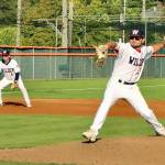 Wilder pitcher Kody Williams winds up to throw in the first inning of Wilder Seniors 10-0 win over Cascade Baseball Club Crush at Civic Field on Thursday. Wilders Cody Romero backs up the play at third base. (Dave Logan/for Peninsula Daily News)