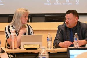 Sequim City Council member Vicki Lowe and Sequim School Board president Eric Pickens talk at a joint meeting at the city councils chambers on June 25. (Michael Dashiell/Olympic Peninsula News Group)