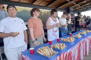 Hot dog eating contestants, from left, Jericho Stuntz of Port Angeles, Lincoln Forrest of Port Angeles, Sebastian Gagnon of Port Angeles, Leo Chouinard of Waupaca, Wisc., Ian Bravender of Port Angeles and Rickie Sanchez of Portland, Ore., chow down on hot dogs during Thursdays Independence Day contest at Port Angeles City Pier. Stantz won the contest by eating 8 1/2 hot dogs in 10 minutes, earning him a $10 cash card from Swains General Store. (Keith Thorpe/Peninsula Daily News)