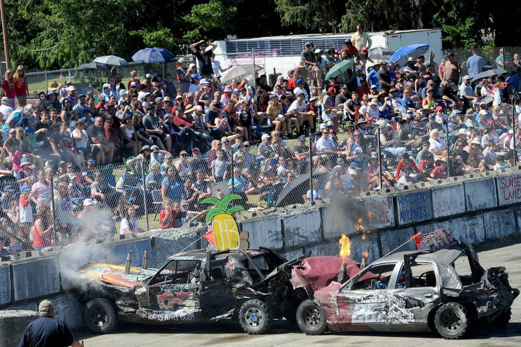There was a lot of smoke and flames during the Forks Fourth of July celebration at the Tillicum Park Arena as a large crowd gathered to watch their favorite demolition cars in action. (Lonnie Archibald/for Peninsula Daily News)
