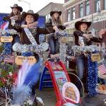 Clallam County Fair royalty, from left, Princess Aliya Gillett of Forks, Princess Tish Hamilton of Port Angeles, Queen Brooklyn McKnight of Port Angeles and Princess Olivia Ostlund of Sequim, ride on their float on Thursday in Port Angeles. (Keith Thorpe/Peninsula Daily News)